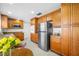 Cozy kitchen with stainless steel appliances, wooden cabinets, and adjacent breakfast table at 6345 Dartmouth N Ave, St Petersburg, FL 33710