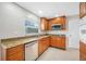 Modern kitchen featuring stainless steel appliances, granite countertops, and wooden cabinets at 6345 Dartmouth N Ave, St Petersburg, FL 33710