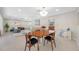Open-concept living room and dining area with beach-themed decor, lots of natural light, and terrazzo floors at 6345 Dartmouth N Ave, St Petersburg, FL 33710