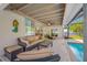 Covered patio with a comfortable seating area and an inviting view of the pool at 6345 Dartmouth N Ave, St Petersburg, FL 33710