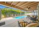 Inviting screened-in pool area with outdoor seating, lush landscaping, and ample space for recreation at 6345 Dartmouth N Ave, St Petersburg, FL 33710