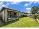 The home's backyard has a covered patio, grill, and play house at 6477 Dutton Dr, Wesley Chapel, FL 33545