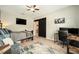 This bedroom has hardwood floors, a barn door leading to closet, and an attached workspace at 6477 Dutton Dr, Wesley Chapel, FL 33545