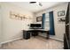 A cozy room featuring artwork, a ceiling fan, carpet, and a corner desk setup at 6477 Dutton Dr, Wesley Chapel, FL 33545
