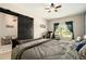 Bedroom showcasing a barn door leading to a closet, with a ceiling fan, and a nearby workspace at 6477 Dutton Dr, Wesley Chapel, FL 33545