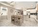 Bright dining area features modern lighting, tile flooring and ample natural light at 6477 Dutton Dr, Wesley Chapel, FL 33545