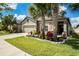 Charming home featuring a two-car garage, well-manicured lawn, and a beautifully landscaped front yard at 6477 Dutton Dr, Wesley Chapel, FL 33545