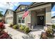 Charming home exterior featuring an American flag and well-manicured landscaping at 6477 Dutton Dr, Wesley Chapel, FL 33545