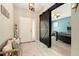 Inviting foyer featuring a welcome bench, tile flooring and a sliding barn door at 6477 Dutton Dr, Wesley Chapel, FL 33545