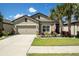 Charming single-story home with a well-manicured lawn, landscaping and a two-car garage at 6477 Dutton Dr, Wesley Chapel, FL 33545