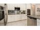 Close-up of kitchen area featuring stainless steel appliances, granite countertops, and a tiled backsplash at 6477 Dutton Dr, Wesley Chapel, FL 33545