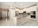 The bright kitchen has stainless steel appliances and a central island with a granite countertop at 6477 Dutton Dr, Wesley Chapel, FL 33545