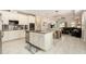 Open kitchen with stainless steel appliances, granite countertops, tile backsplash, and center island at 6477 Dutton Dr, Wesley Chapel, FL 33545