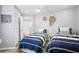 Bright bedroom showcasing two twin beds with stylish striped bedding and coastal-themed decor at 700 S Harbour Island Blvd # 547, Tampa, FL 33602