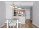 The eat in kitchen with wooden cabinets and stainless steel appliances is adjacent to a dining area with glass table and chairs at 700 S Harbour Island Blvd # 547, Tampa, FL 33602