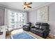 Relaxing living room with a balcony, ceiling fan, stylish decor, seating area with comfortable seating, and a blue accent rug at 700 S Harbour Island Blvd # 547, Tampa, FL 33602
