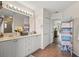 Bright bathroom with double vanity, a large mirror, and a decorative folding screen at 7288 Castleberry Ter, Englewood, FL 34224