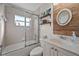 Bathroom with a tiled shower and tub, decorative shelves, and a vessel sink at 7288 Castleberry Ter, Englewood, FL 34224