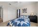 Comfortable bedroom with neutral walls and a tiger print hanging on the wall at 7288 Castleberry Ter, Englewood, FL 34224