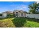 Inviting single-story home with lush front lawn, screened entrance and attached two-car garage at 7288 Castleberry Ter, Englewood, FL 34224