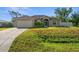 Charming one-story home with a well-maintained lawn and attached two-car garage at 7288 Castleberry Ter, Englewood, FL 34224