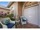 Cozy front porch with seating, plants, and lantern, leading to the front door at 7288 Castleberry Ter, Englewood, FL 34224