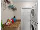 Laundry room with granite countertops and a stacked washer and dryer at 7288 Castleberry Ter, Englewood, FL 34224