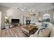 Bright living room featuring wood floors, a white sofa, and a decorative chandelier at 7288 Castleberry Ter, Englewood, FL 34224