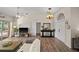Open-concept living room featuring wood-look floors, sliding doors to the lanai, and ample space at 7288 Castleberry Ter, Englewood, FL 34224