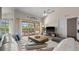 Bright living room featuring wood-look floors, sliding doors to the lanai, and comfortable seating at 7288 Castleberry Ter, Englewood, FL 34224