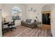 Sitting area off of the living room featuring wood-look floors, large window, and desk space at 7288 Castleberry Ter, Englewood, FL 34224