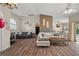 Bright living room featuring wood-look floors, high ceilings, and ample natural light at 7288 Castleberry Ter, Englewood, FL 34224