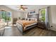 Well-lit main bedroom with access to the pool area and a decorative ceiling fan at 7288 Castleberry Ter, Englewood, FL 34224