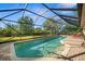 A beautiful screened-in pool with a sunbathing area and lovely outdoor views at 7288 Castleberry Ter, Englewood, FL 34224