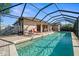 A serene screened-in pool area with lounge chairs and ample space for relaxation at 7288 Castleberry Ter, Englewood, FL 34224