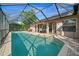 A refreshing screened-in pool with patio area for relaxing and entertaining outdoors at 7288 Castleberry Ter, Englewood, FL 34224
