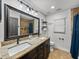 Bathroom featuring double sinks, granite counters, and dark wood cabinets providing ample storage at 7508 W Short Rd, Plant City, FL 33565
