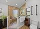 Well-lit bathroom featuring a walk-in shower with glass partition and neutral tile at 7508 W Short Rd, Plant City, FL 33565