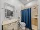 Well-lit bathroom with tile shower, elegant vanity and a framed mirror at 7508 W Short Rd, Plant City, FL 33565
