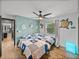 Nicely decorated bedroom with two beds, ceiling fan, and nautical decor on wall at 7508 W Short Rd, Plant City, FL 33565