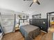 Bedroom features wood floors, black accent wall, and modern decor at 7508 W Short Rd, Plant City, FL 33565