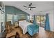 Bright bedroom with a sliding glass door, wood-look floors, and neutral decor, perfect for relaxing at 7508 W Short Rd, Plant City, FL 33565