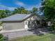 Exterior view of a gray home with a metal roof and a fenced yard at 7508 W Short Rd, Plant City, FL 33565