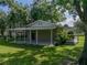 Exterior view of a tan home with covered parking and a brick patio at 7508 W Short Rd, Plant City, FL 33565