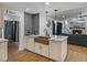 Updated kitchen with a farmhouse sink, granite countertops, and stone fireplace view at 7508 W Short Rd, Plant City, FL 33565