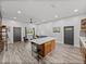 Spacious kitchen and living area with hardwood floors and a large island at 7508 W Short Rd, Plant City, FL 33565