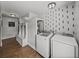 Laundry room featuring modern washer and dryer units and mudroom entryway at 7508 W Short Rd, Plant City, FL 33565