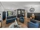 Open-concept living room with stylish decor, wood-look floors, and seamless flow to the dining area at 7508 W Short Rd, Plant City, FL 33565