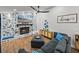 Charming living room with stone fireplace, wood-look floors, and stylish decor, creating a warm and inviting space at 7508 W Short Rd, Plant City, FL 33565