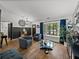 Inviting living room with wood-look floors and ample natural light from the large window at 7508 W Short Rd, Plant City, FL 33565